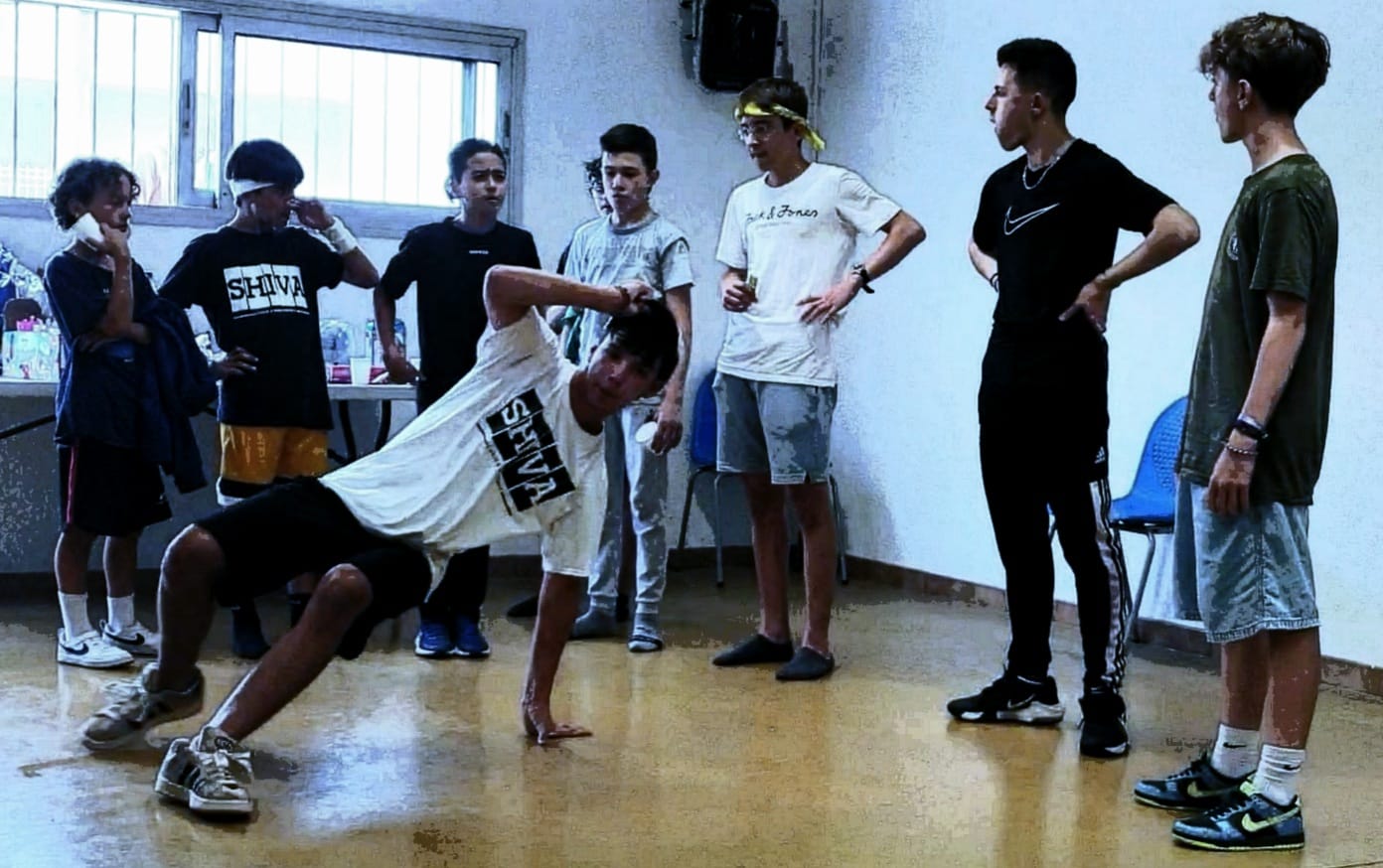 Edgar danse dans un cercle entouré des élèves SHIVA